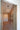 ET2 Orb II bubble glass pendant glowing in a hallway beside a wood-paneled wine display