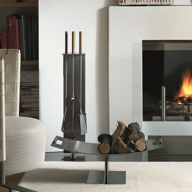 Conmoto Peter Maly Fireside Tools with Floor Stand, next to an open fireplace with a log holder