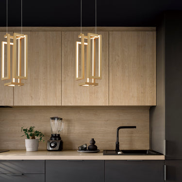 ET2 Penrose gold open-cornered cube pendants hanging in front of wood kitchen cabinets