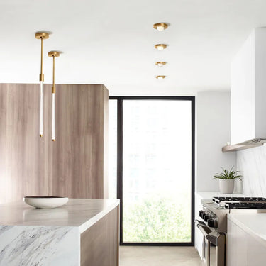 hobos 21.3" Adjustable Height Pendant | Natural Brass/Bronze by Visual Comfort installed in a modern kitchen island.