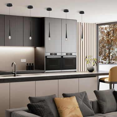 ET2 Pierce crystal pendants hanging in a row over a modern kitchen counter with dark cabinetry