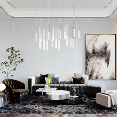 ET2 Pipette glass tube pendants in a cluster over a living room with a black sofa and marble coffee table