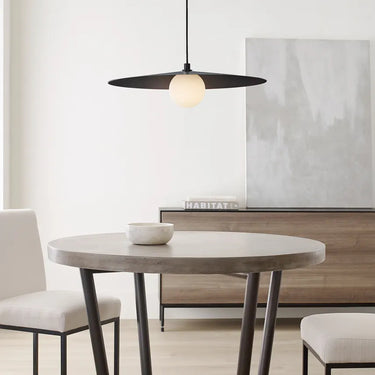 Matte Black Pirlo 22 inch pendant light hanging above a dining room table