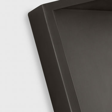 The Punto 10 dimmable wall light creating a warm, indirect glow in a living room at night.