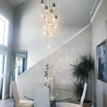 ET2 Quartz crystal pendants cascading down a stairwell above a glass dining table
