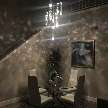 ET2 Quartz crystal pendants lit at night in a stairwell, with light spots across the wall