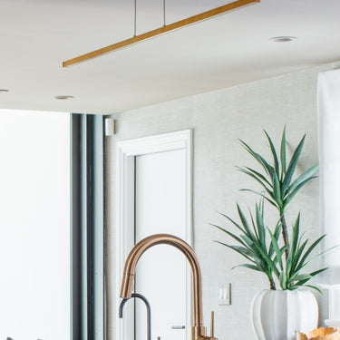 Image of Long 50 Inch Aged Brass Satin Nickel Linear Suspension Light for Kitchen Island.
