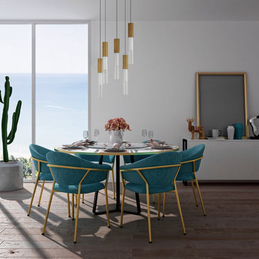 ET2 Reeds pendant cluster of Gold housings and clear reeded tubes over a dining table with teal chairs