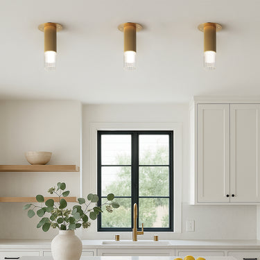 ET2 Reeds fluted gold flush mounts in a row on a white kitchen ceiling above a window
