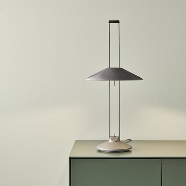 Regina T aluminium desk lamp with a conical indirect-light shade on a sideboard