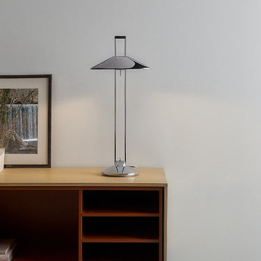 Regina T table lamp styled with framed artwork and a bookshelf console