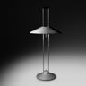 Regina T lamp lit in a dark room, casting a pool of indirect light on the surface below