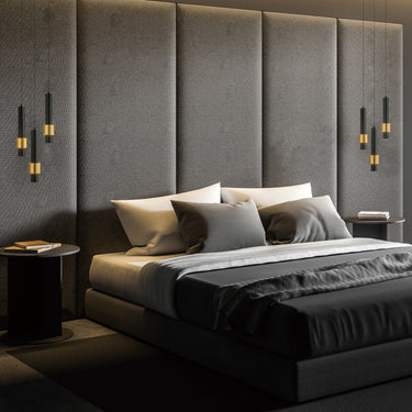 ET2 Reveal pendants hanging as bedside lights on either side of a dark padded headboard
