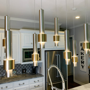 Lit ET2 Reveal pendants over a kitchen counter in a white-cabinet kitchen