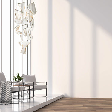 ET2 Rinkle acrylic sheet pendant hanging high in a tall white living room above a striped sofa