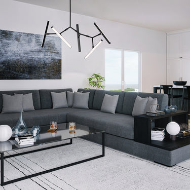 ET2 Robotica arm pendant over a gray sectional sofa and coffee table in a living room open to a kitchen