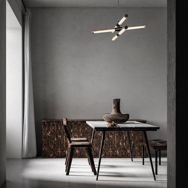 ET2 Rollo tube pendant above a dark dining table in a room with a gray plaster wall