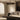 Ceres Uplighter pendant above a low coffee table in a living room with a large framed artwork