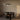 Trace Circular chandelier above a dark dining table in a dining room with an arched doorway