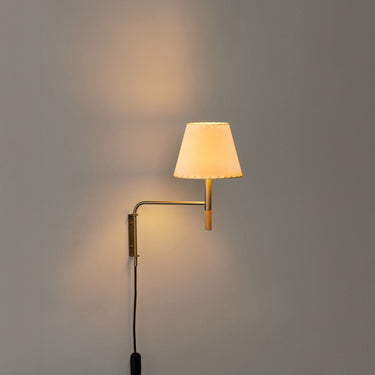 BC Swing Aram Wall Sconce with stitched beige parchment shade and warm LED lighting for modern bedrooms