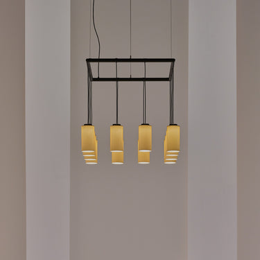 Rectangular Cirio Cuadrada pendant light above a modern dining table