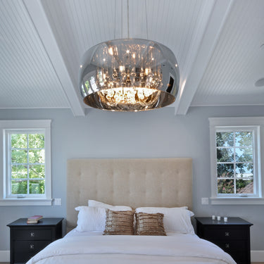 ET2 Sense mirror chrome flush mount centered over the foot of a white-bedded bed under a beamed vaulted ceiling