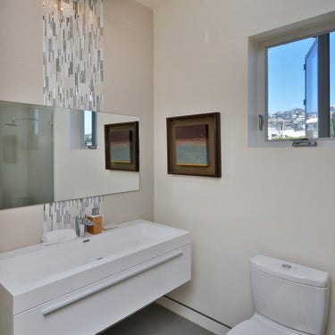 ET2 Sense mirror chrome flush mount high above a white floating vanity and toilet in a bright bathroom