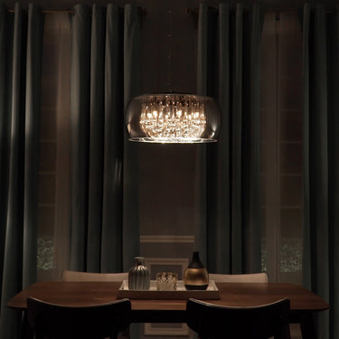 ET2 Sense mirror chrome flush mount glowing over a dark wood dining table in a room with tall charcoal drapes
