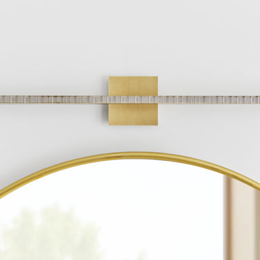 Modern natural brass LED wall light with serrated glass for home and hospitality bathrooms