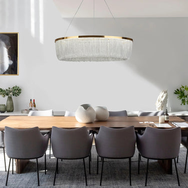 Shoebill Rainfall LED Chandelier illuminating a modern dining room