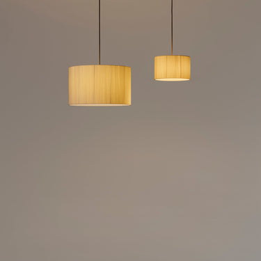Designer pendant light with natural ribbon shade by Santa & Cole for kitchens, lounges, and hotels
