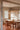 Modern cylindrical pendant light with white linen shade by Santa & Cole for dining rooms