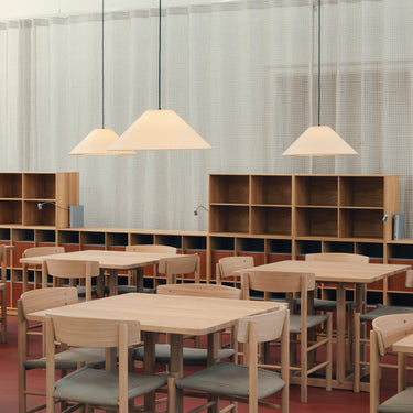 Sísísí MT5 pendant light with white parchment shade in a commercial setting