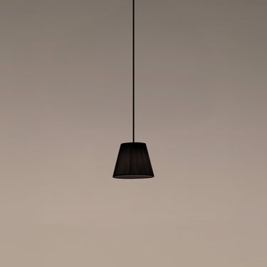 Santa & Cole Sísísí Cónicas PT1 pendant light with black ribbon shade and black canopy hanging in a modern dining room