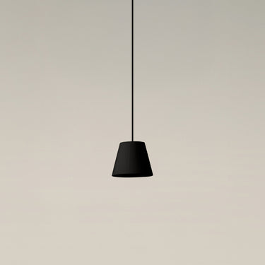 Black ribbon Sísísí Cónicas PT1 pendant lamp by Santa & Cole with black ceiling canopy and warm ambient lighting