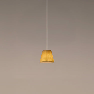 Santa & Cole Sísísí Cónicas PT1 pendant lamp with natural ribbon shade suspended above a modern dining table