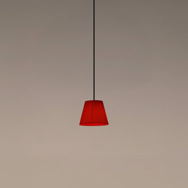 Santa & Cole Sísísí Cónicas PT1 pendant light with red-amber ribbon shade and warm decorative glow