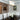ET2 Spiral crystal bead drum in a dining room with white tufted chairs and a dark table