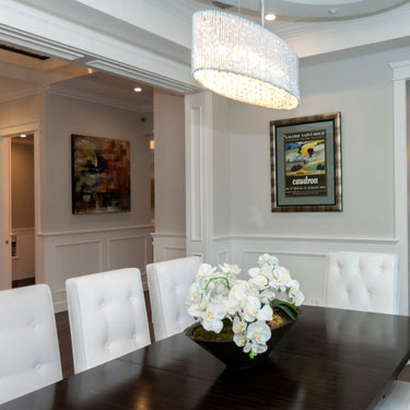 ET2 Spiral crystal bead drum in a dining room with white tufted chairs and a dark table
