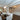 ET2 Spiral crystal drum pendant in a dining room with a staircase