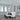 ET2 Spiral crystal drum pendant over a dining table in a tall room