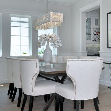 ET2 Spiral rectangular crystal bead pendant above a dining table with white chairs beside a tall window, close view