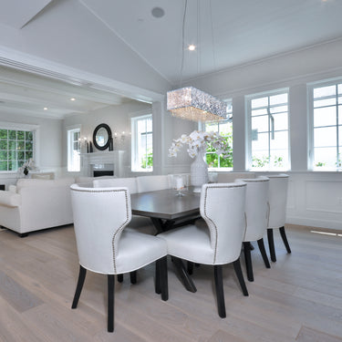 ET2 Spiral rectangular crystal bead pendant over a dark table in a white dining room with wood floors, wide view