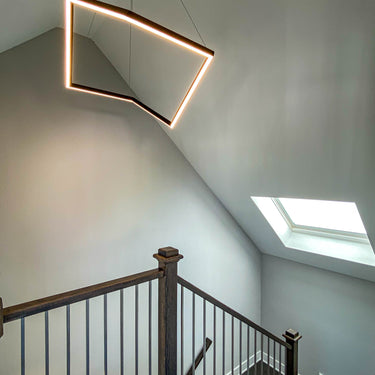 ET2 Stealth angular frame pendant over a staircase with a skylight
