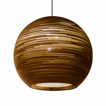 Close-up view: laser-cut edge detail on Graypants Sun recycled cardboard pendant.