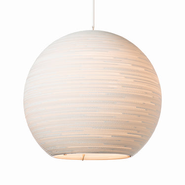Warm light filtering through corrugated cardboard layers of Graypants Sun White Scraplight. 