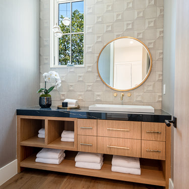 ET2 Swank acrylic orb pendant in a bathroom with a vanity and round mirror