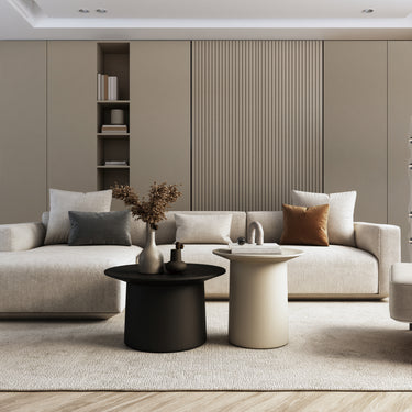 ET2 Syndicate tall clear hourglass glass pendant with black bands beside a beige sectional sofa in a living room
