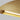 Natural Brass Bau 50 linear pendant light with integrated LED lighting, providing a soft, ambient glow.