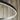 Sleek matte black LED ring pendant fixture from Visual Comfort, mounted on high ceiling
6.